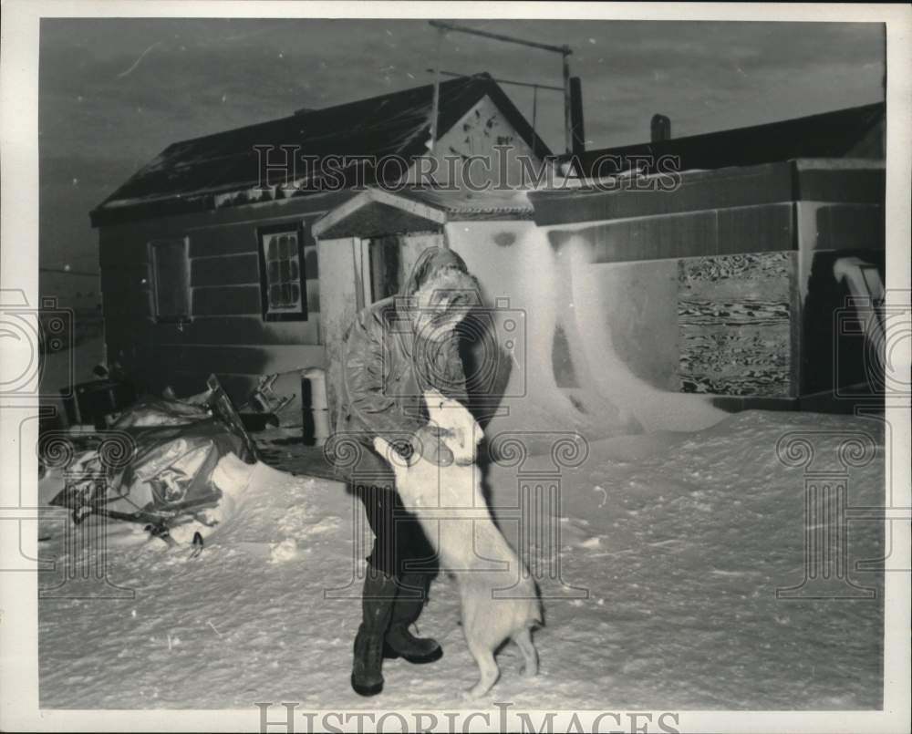 1967 Press Photo Dr. John Hester plays with husky before treating Eskimos in AK- Historic Images