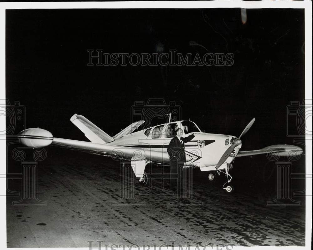 Press Photo Pilot Peter Gluckmann examines his J-35 Bonanza plane - pix39466