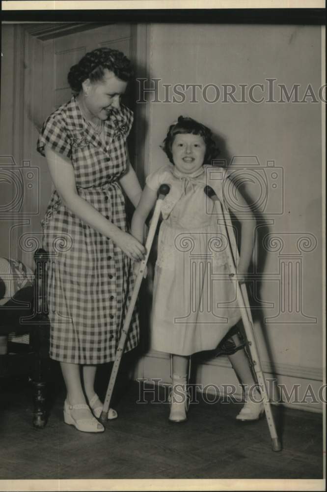1951 Press Photo Nancy Witherow Gets Help with Crutches - pna00471