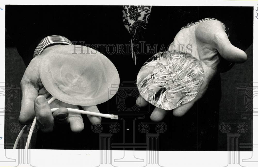 1992 Press Photo Doctor Showing Saline and Silicone Breast Implants - pna05702- Historic Images