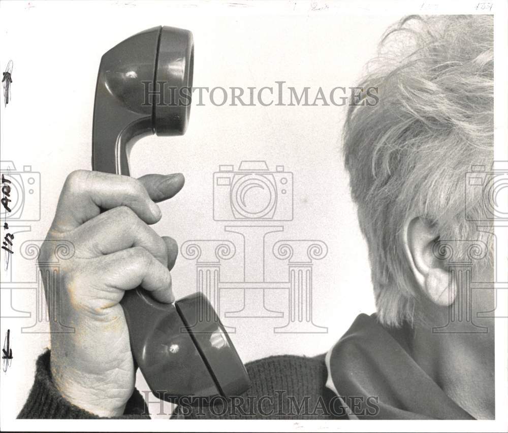 1990 Press Photo Person Holding Telephone Receiver Away from Ear - pna06631- Historic Images