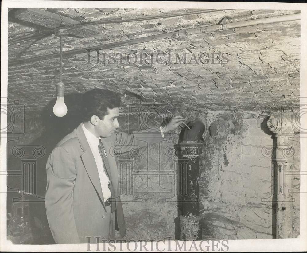 1957 Press Photo Official Inspecting Pipe at Dauphin County Prison Building