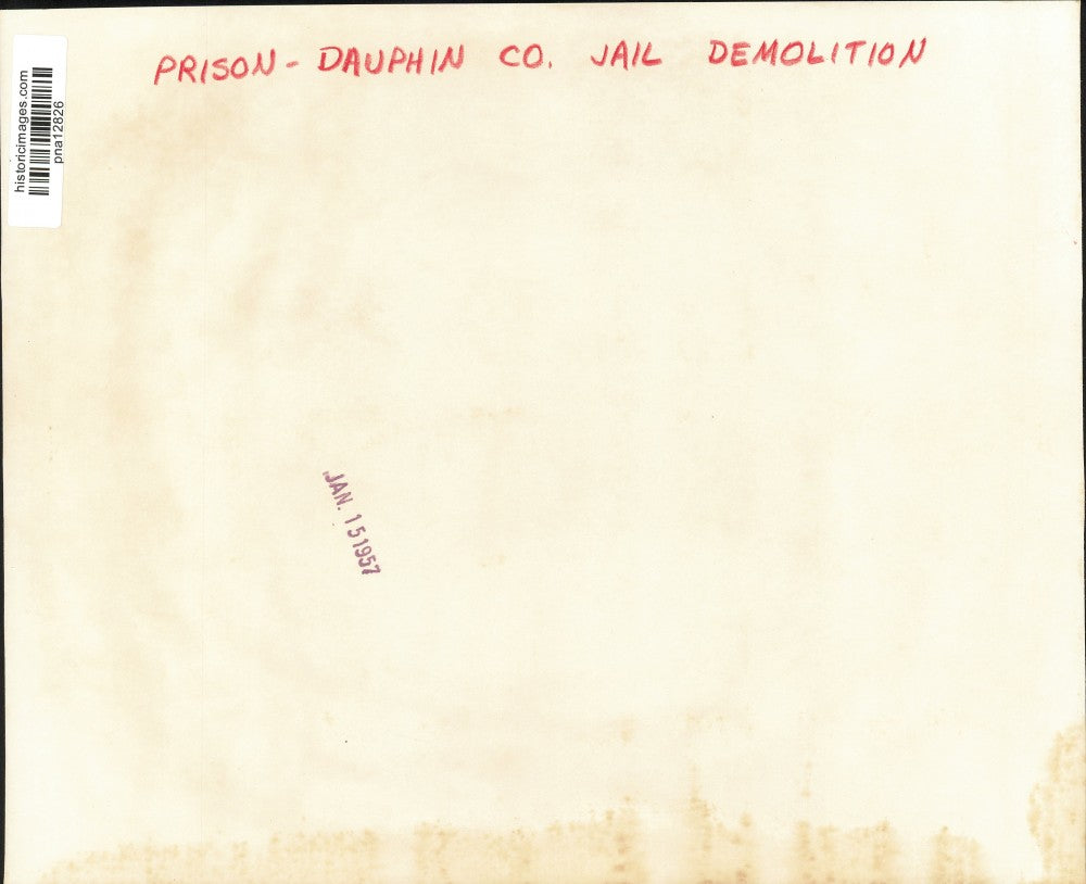 1957 Press Photo Official Inspecting Pipe at Dauphin County Prison Building