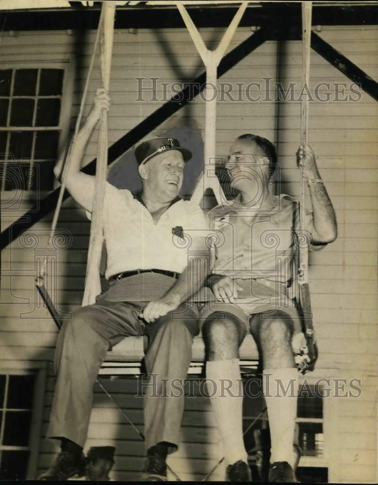 1957 Press Photo Ed Kuykendall sitting in swing with another gentleman, Georgia