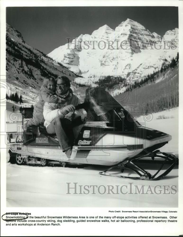 Press Photo Gentleman and young girl on snowmobile at Snowmass Resort, Colorado- Historic Images