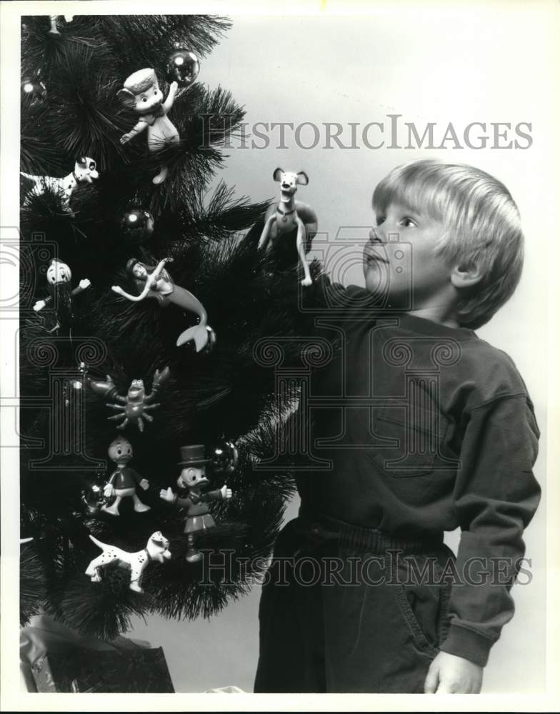 Press Photo Child admiring Disney Bend-EMS Christmas decorations by Just Toys- Historic Images