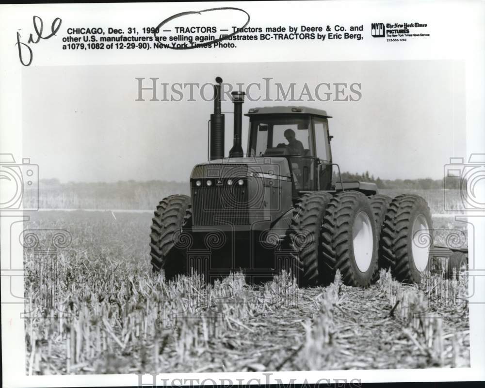 1990 Press Photo Gentleman driving tractor across field, Chicago, Illinois- Historic Images