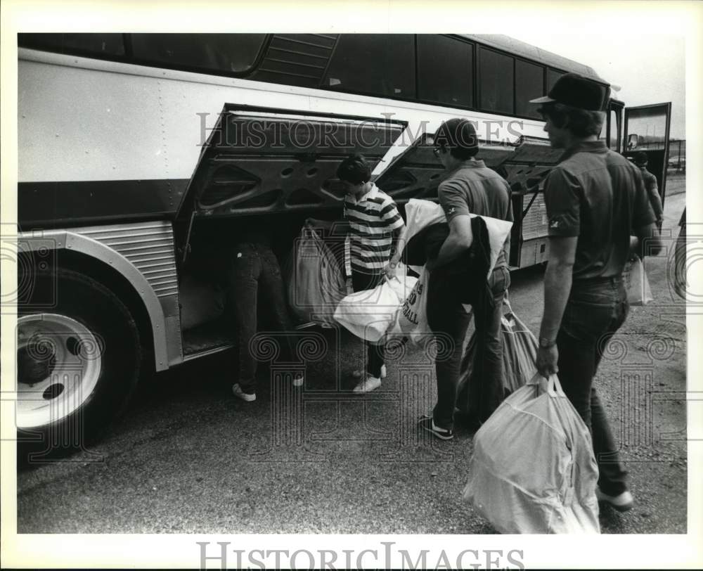 1984 Press Photo Madison High School Football Team Loading Equipment on Bus- Historic Images