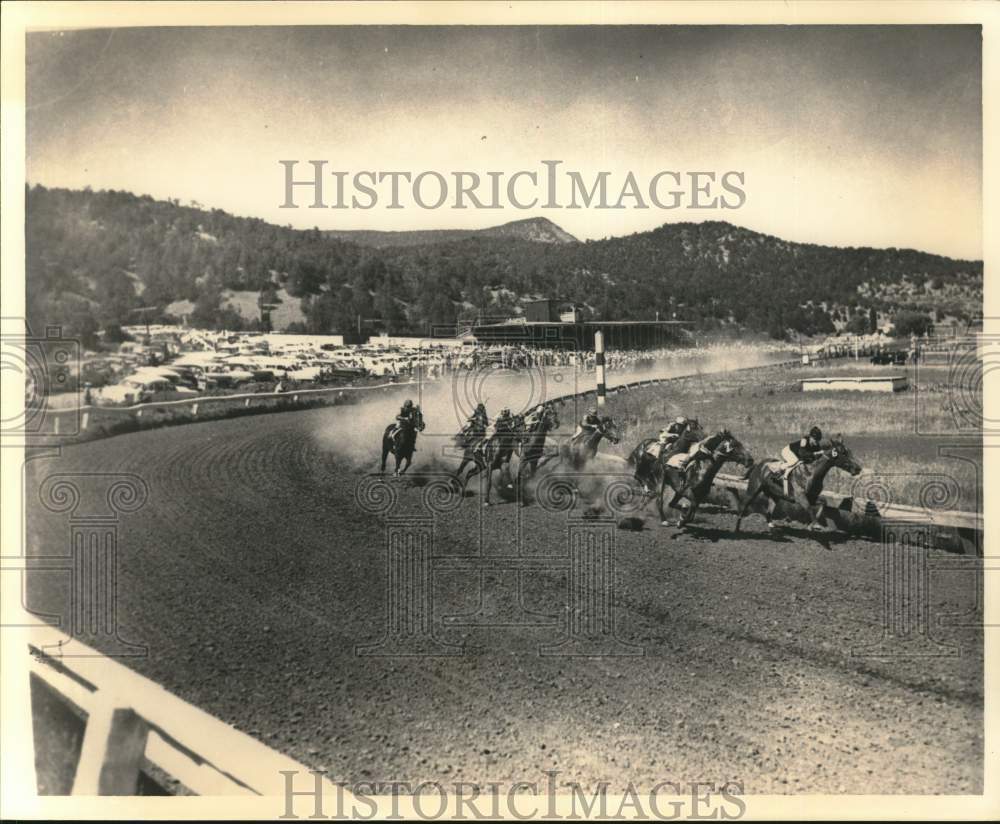 Press Photo Jockeys on their horses coming around turn in race - sab17230- Historic Images
