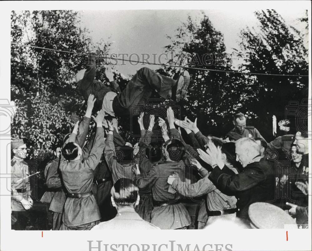 Press Photo General William Simpson thrown into air at victory celebration- Historic Images