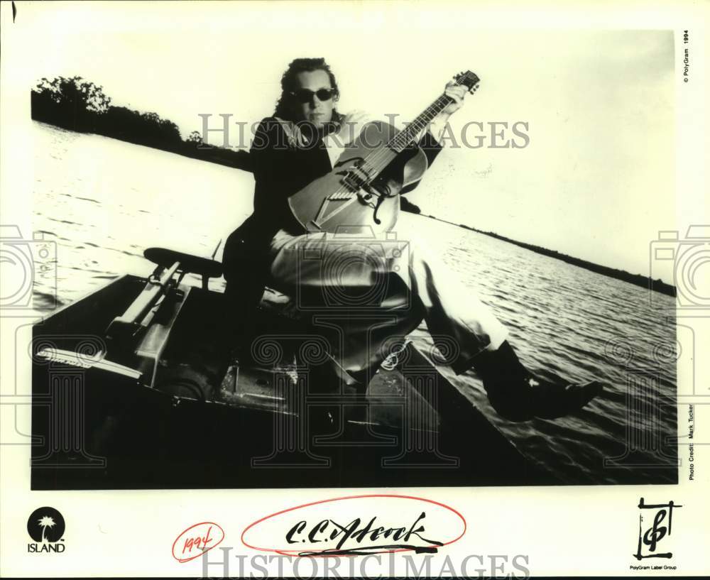 1994 Press Photo C. C. Adcock with his guitar on a boat - sap11124- Historic Images