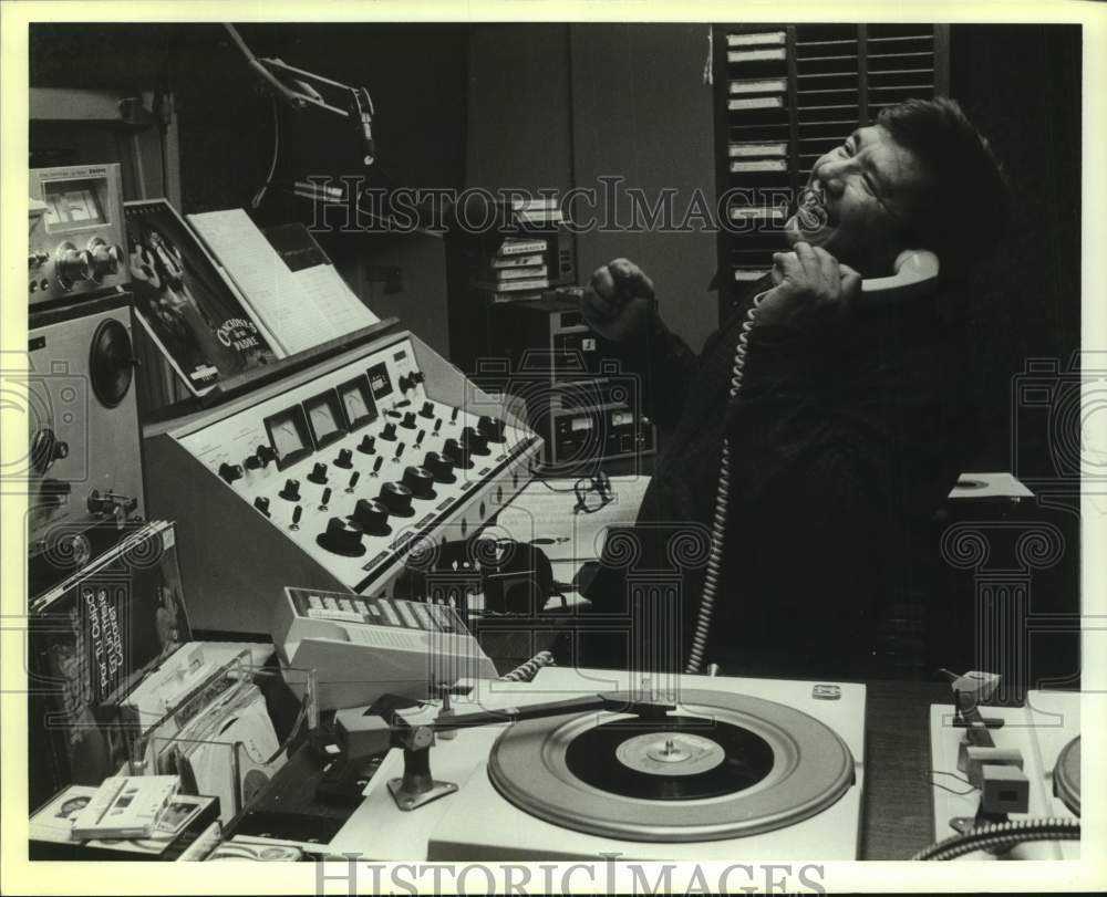 1988 Press Photo Emilio Gonzales on phone laughing at KFHM Radio Station- Historic Images