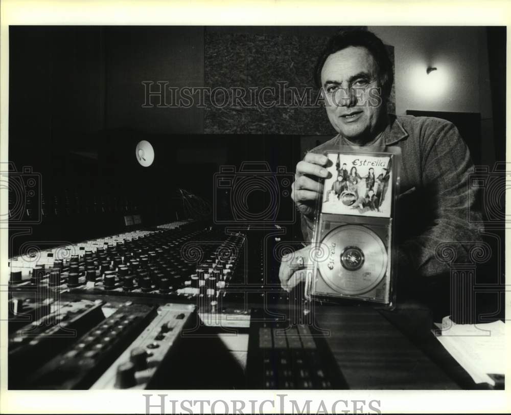 1992 Press Photo Joey Lopez Sr. displays a CD by the band Estrella in Studio- Historic Images