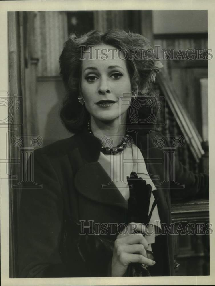 Press Photo Woman Holds Gloves inside Home - sap52932- Historic Images