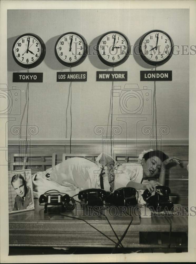 Press Photo Asian Woman Answers Phones Under World Clocks - sap53268- Historic Images