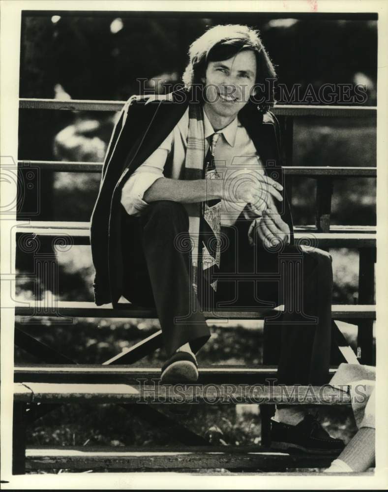 Press Photo Fashion Designer Perry Ellis Poses on Bleachers - sap72334