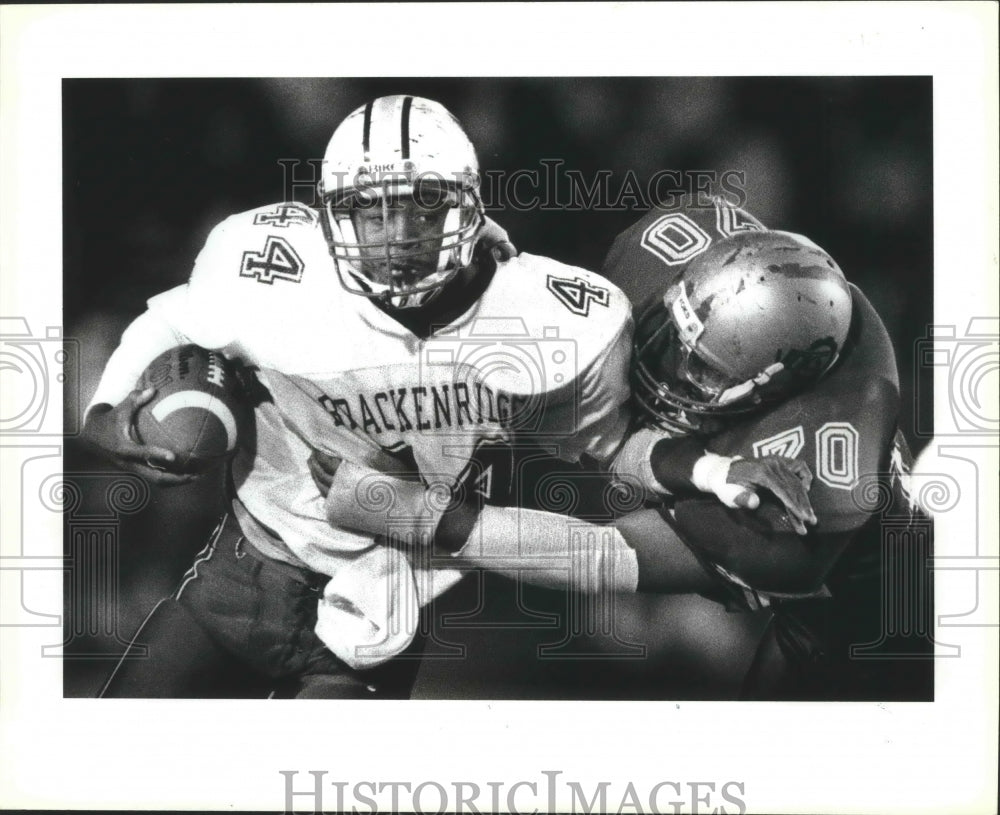 1990 Press Photo Brackenridge and Lanier tangle in a high school football game- Historic Images