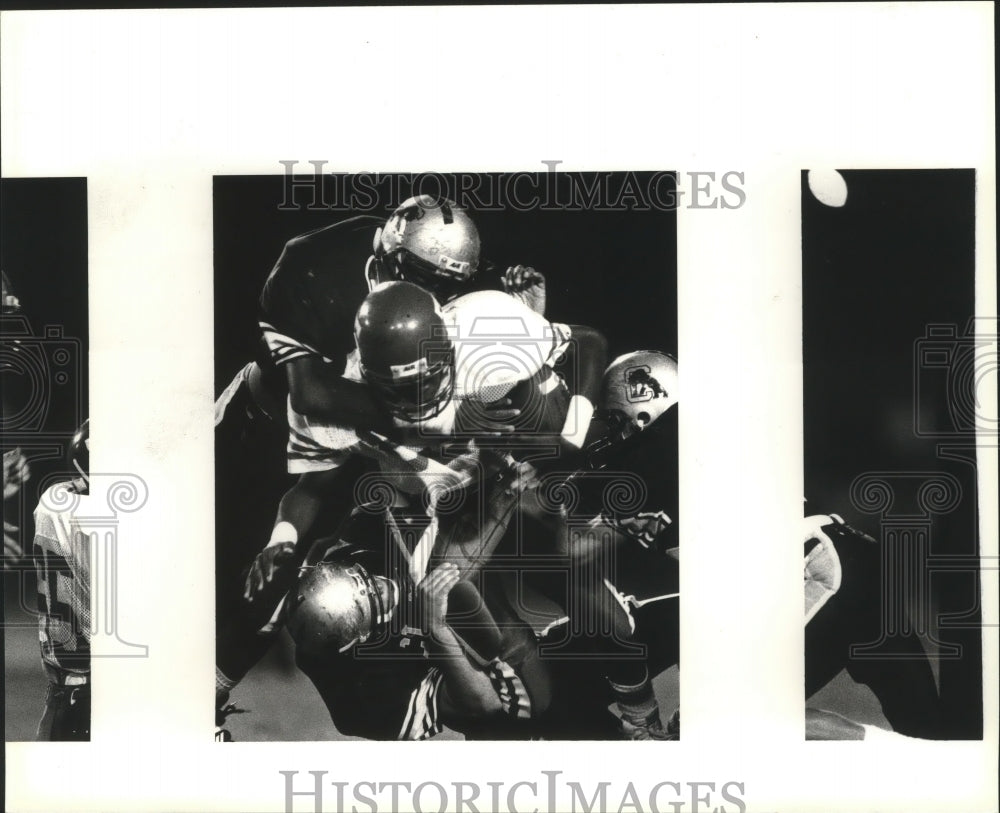 1993 Press Photo Chris White, is dragged down by defenders, Northside Stadium.- Historic Images