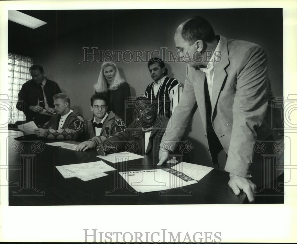 1994 Press Photo Jerod Douglas, Judson High School Football Player Sings Papers- Historic Images