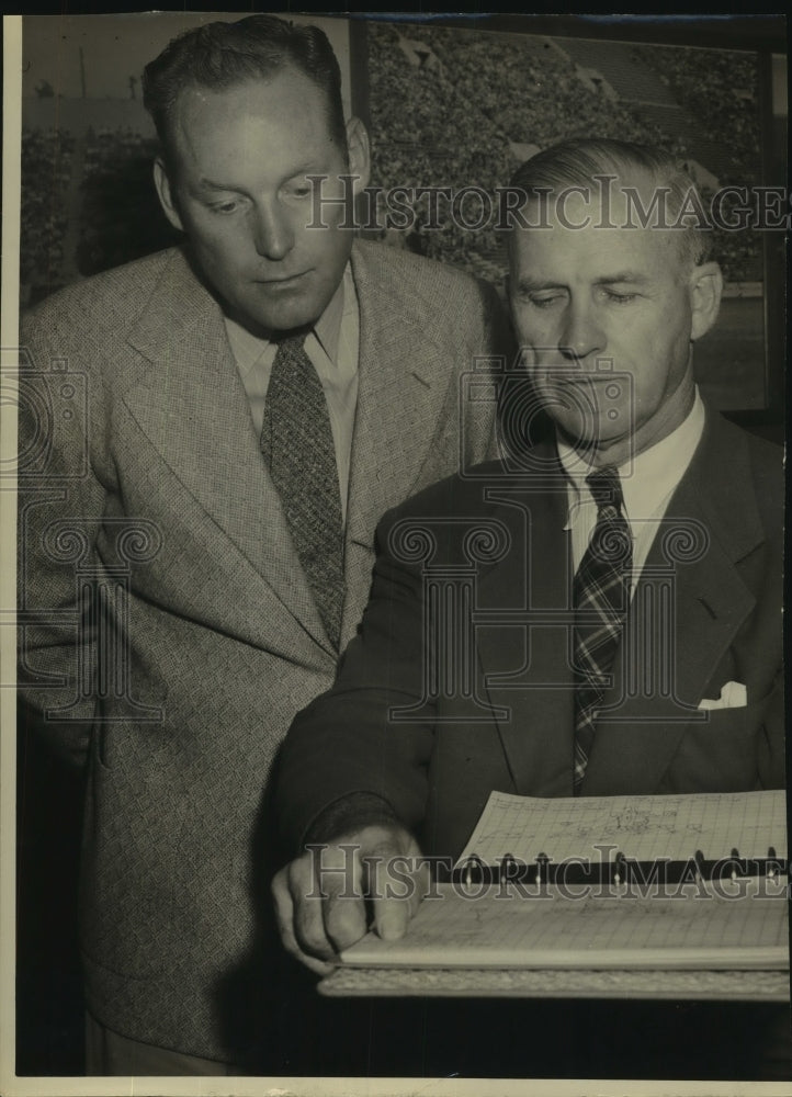 Press Photo Football Coaches Look at Play Book - sas11908- Historic Images