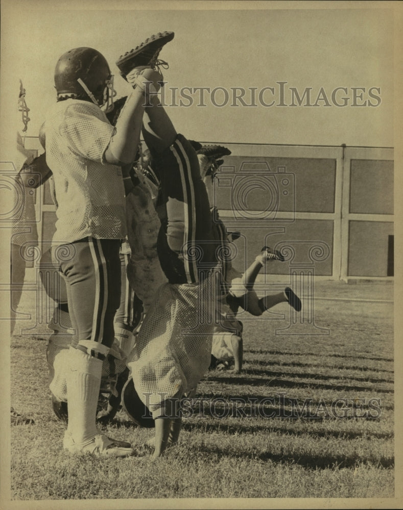 Press Photo Wheatley Football Players Perform Neck Exercise on Field - sas12421- Historic Images