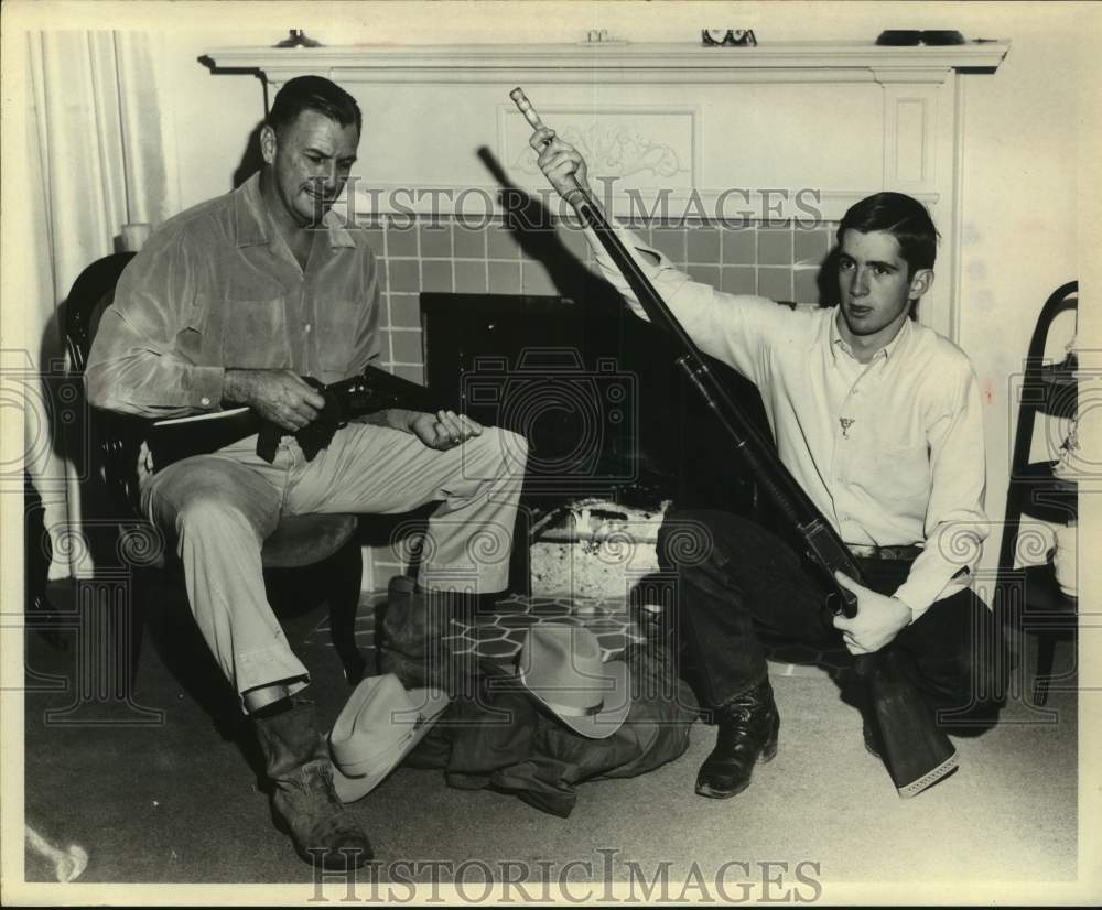 1965 Press Photo Walter Corrigan & Son with Rifles in Front of Fireplace- Historic Images