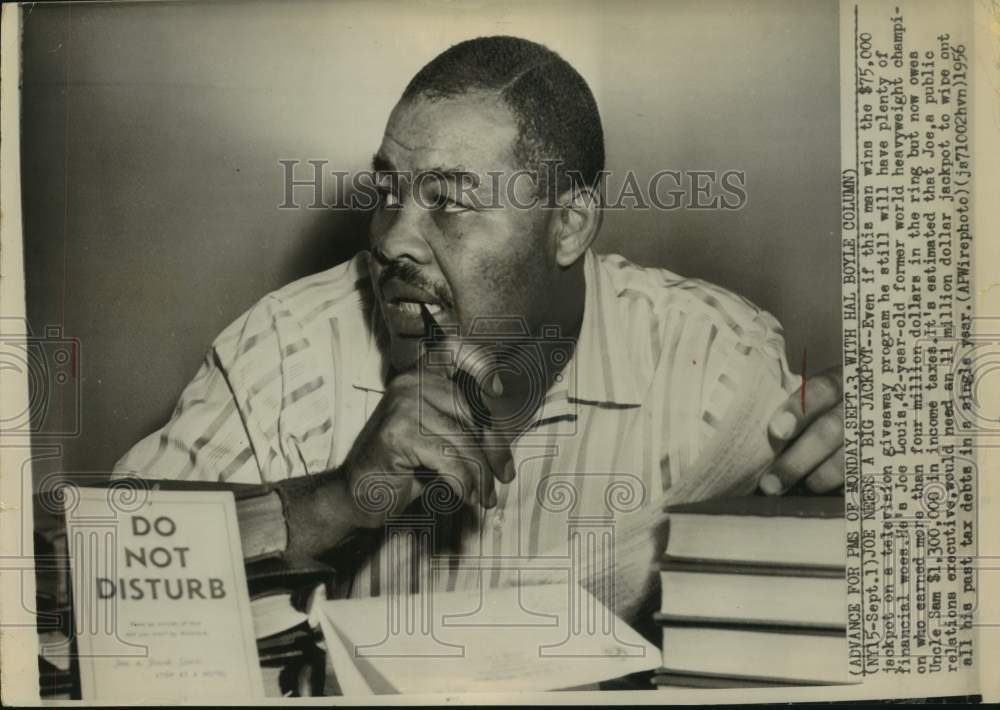 1956 Press Photo Former Boxer Joe Louis Chews on Pen - sas22511- Historic Images