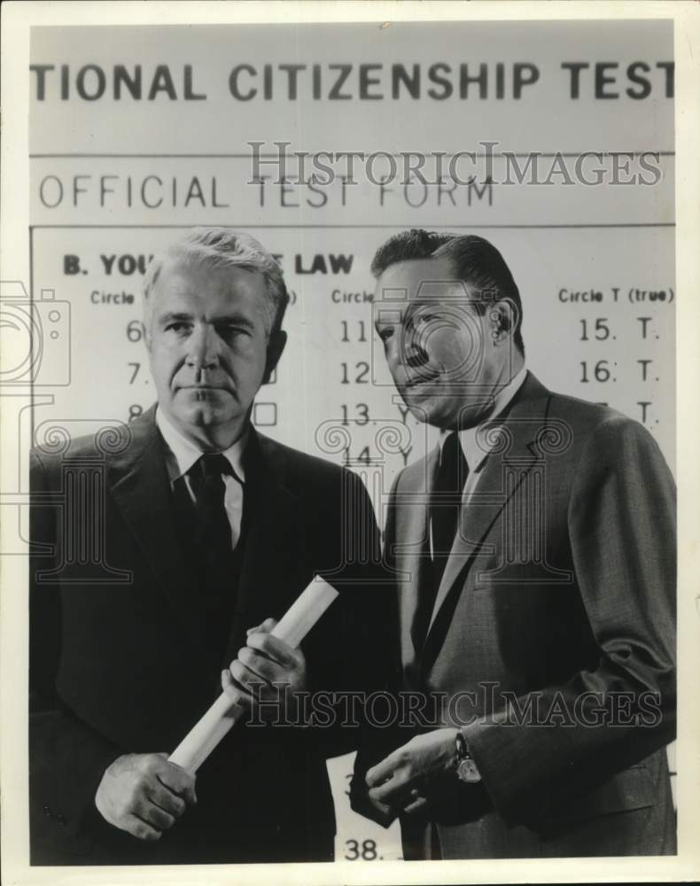1965 Press Photo Harry Reasoner and Mike Wallace investigate citizenship form.- Historic Images
