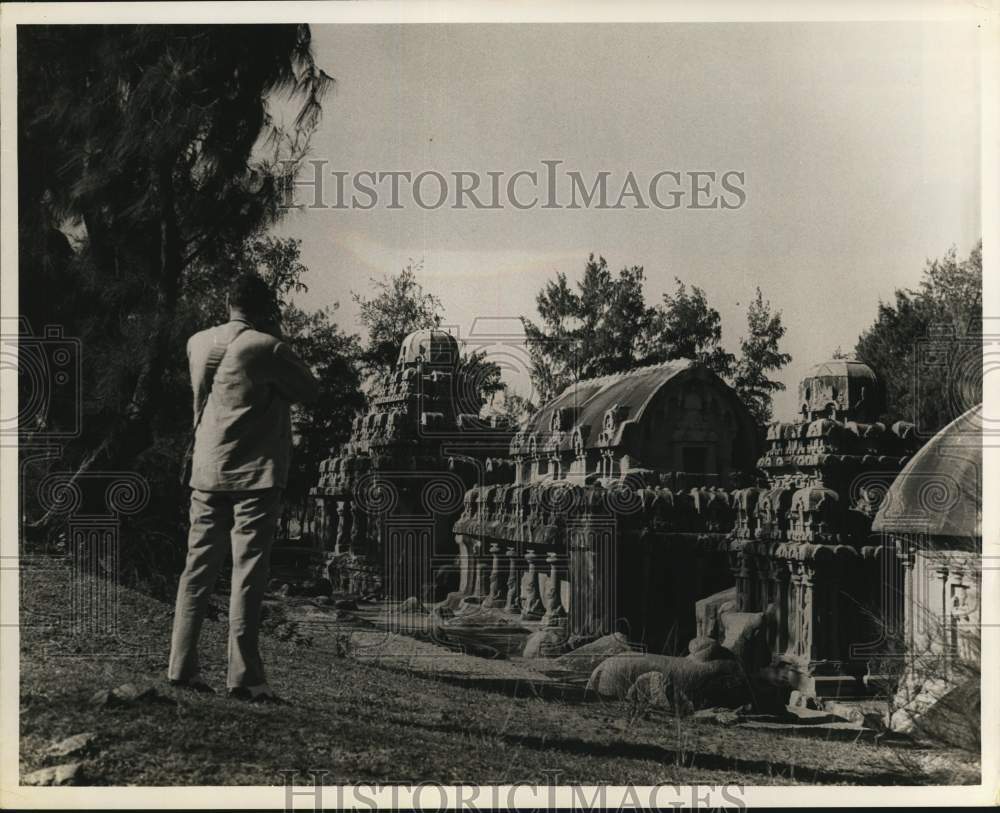 Press Photo Tourist takes picture of Buddhist temples in Madras, India.