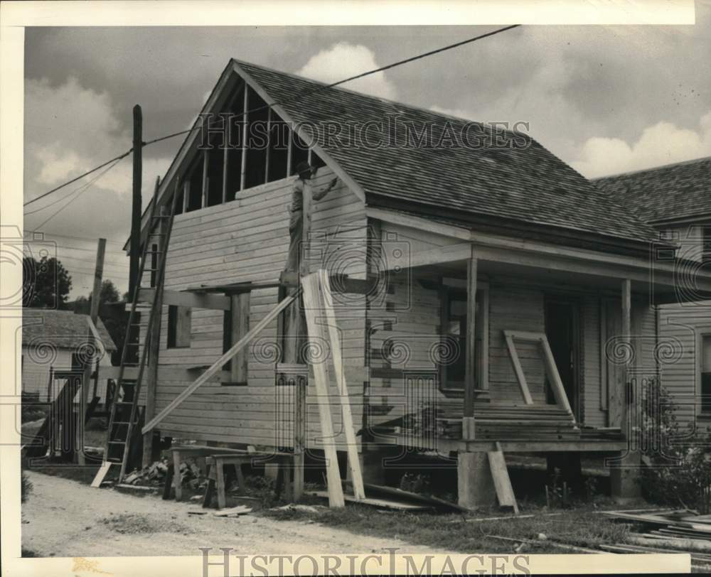 1947 Press Photo Carpenter works to repair fire-damaged home in Texas City, TX- Historic Images