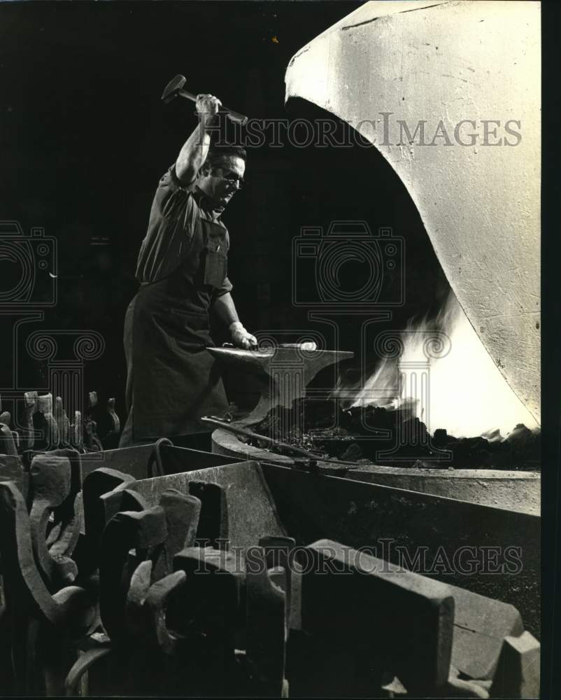 Press Photo A blacksmith forges metal at East Kodak Company in Rochester, NY- Historic Images