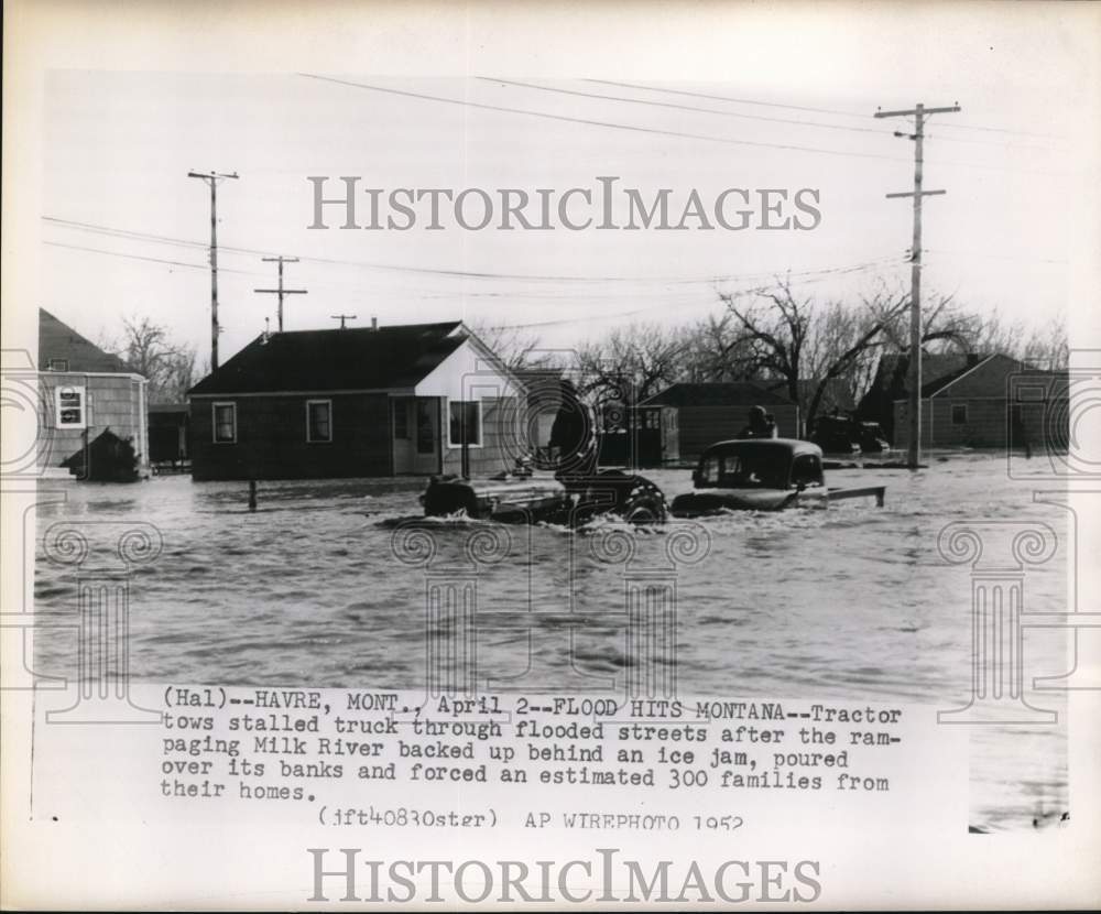 1952 Press Photo Tractor tows stalled truck through flooded Have, Montana street- Historic Images