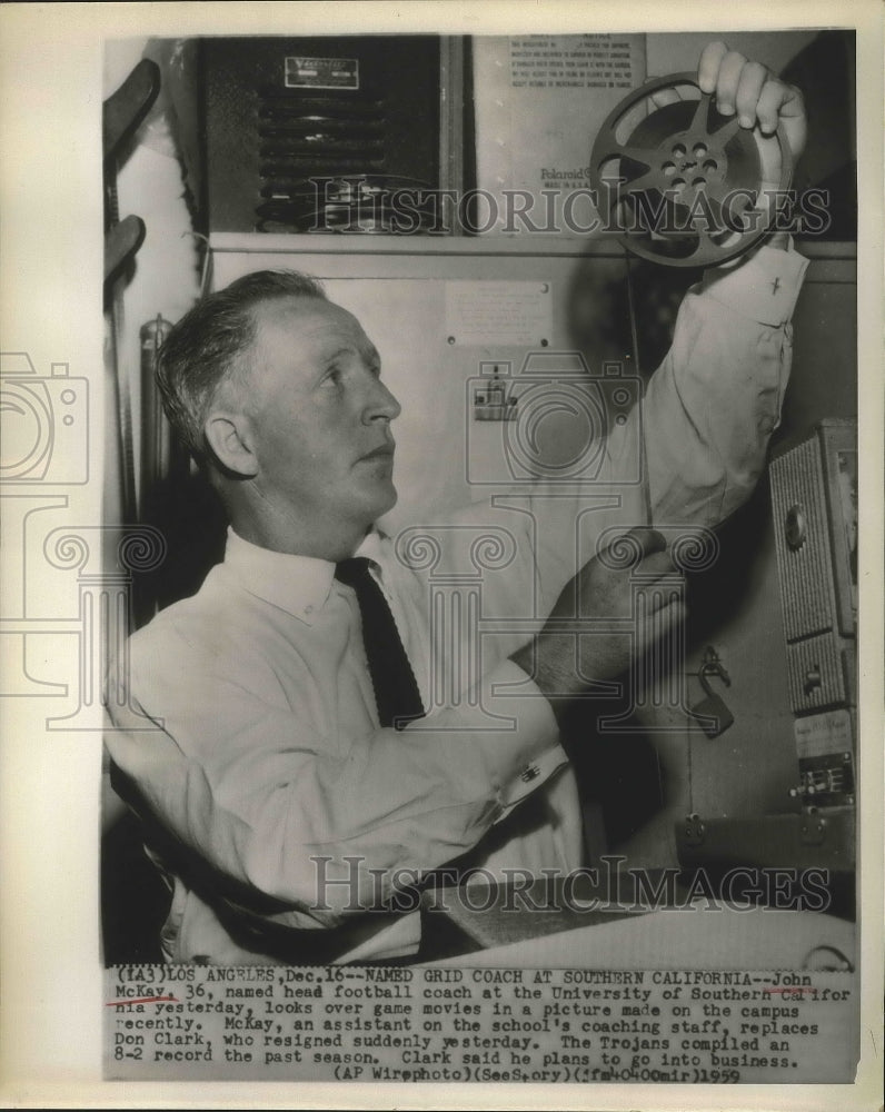 1959 Press Photo John McKay looks over game movies in a picture - sbs00863- Historic Images