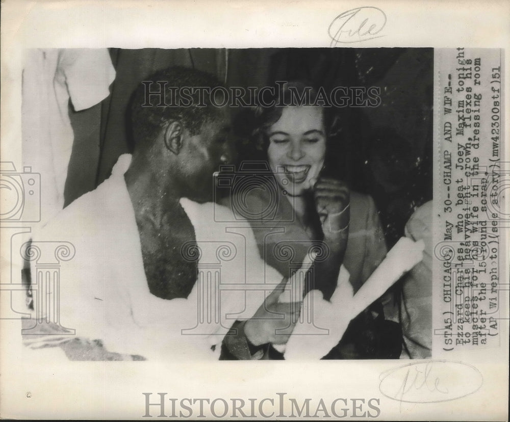 1951 Press Photo Ezzard Charles flexes his muscles for his wife - sbs01064- Historic Images