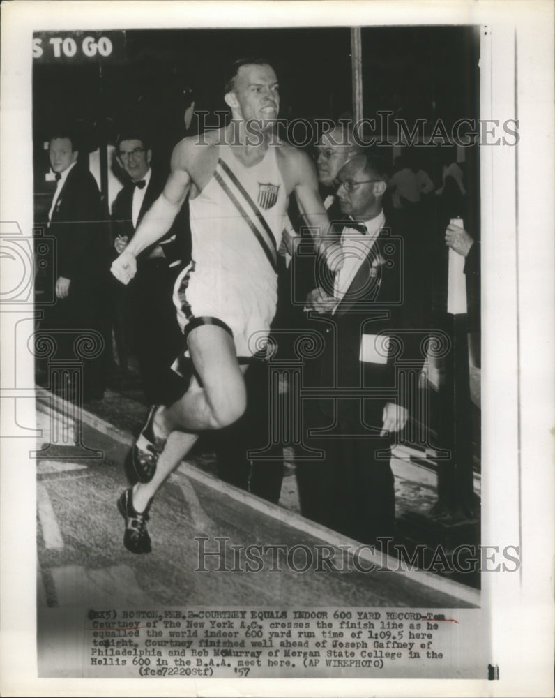 1957 Press Photo Tom Courtney crosses finish line 600 Yard Run - sbs08900- Historic Images