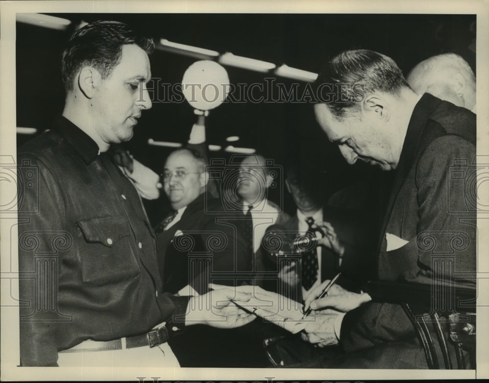 1955 Press Photo James Denerio gets discharges paper signed by Gen. MacArthur