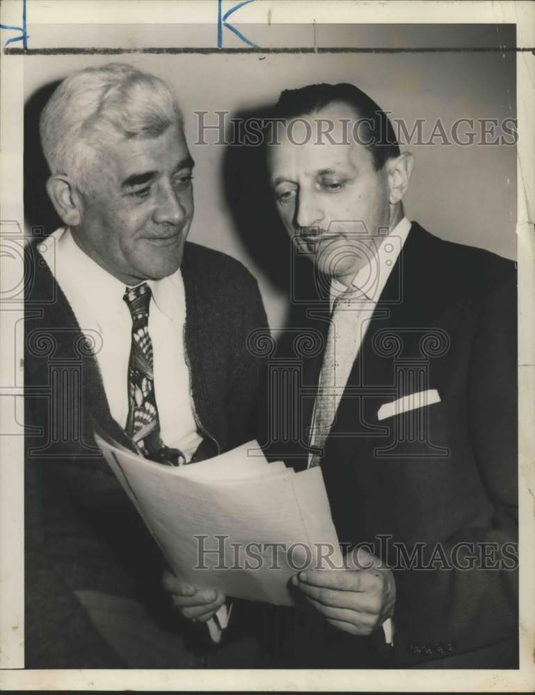Load image into Gallery viewer, 1954 Press Photo Thomas Hinton &amp; friend looking at papers, Brooklyn - sia01624
