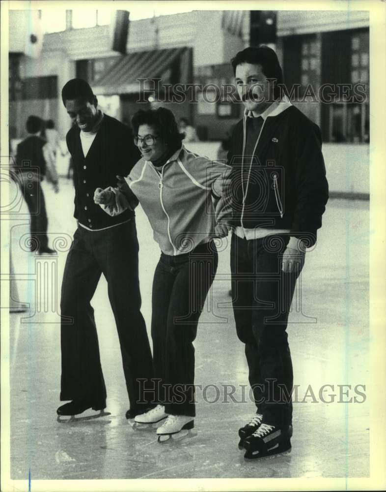 Press Photo Three smiling skaters on an ice rink - sis00339- Historic Images