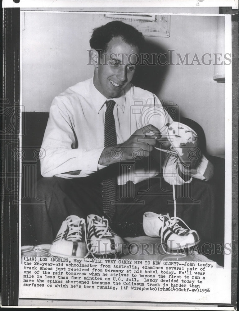 1956 Press Photo John Landy examines new german shoes to run a four minute mile- Historic Images