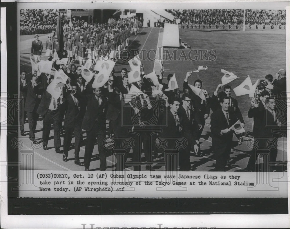 1964 Press Photo Cuban Olympic team wave Japanese flag in opening ceremony- Historic Images