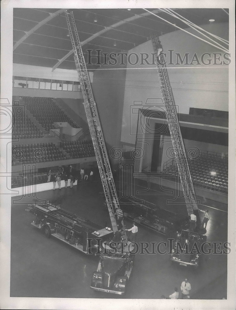 1957 Press Photo Fire trucks and firemen use ladders inside Spokane&#39;s Coliseum- Historic Images