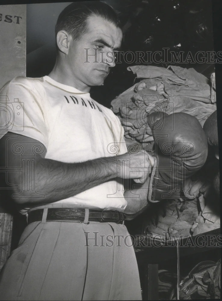 1953 Press Photo Boxing coach Frank Young puts on boxing gloves - sps10826- Historic Images