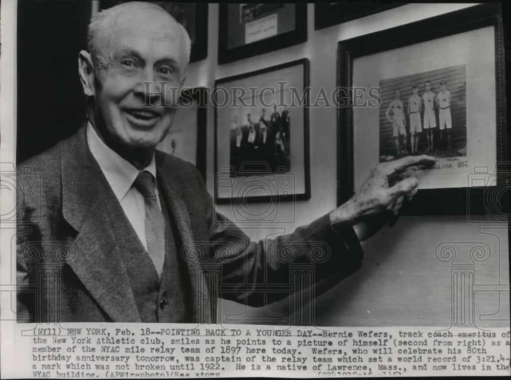 1952 Press Photo Bernie Wefers Points to a Picture of Him in the Mile Relay Team- Historic Images