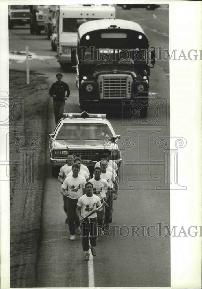 1987 Press Photo Law officers carry the Special Olympics torch near Spokane- Historic Images