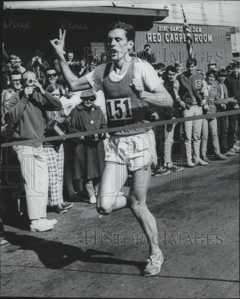 1970 Press Photo Track Runner Ken Moore Holds Two Fingers Up While Running- Historic Images