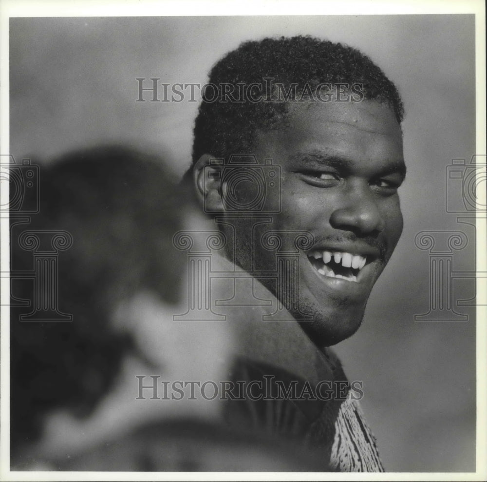 1991 Press Photo Tony Savage, professional football player,laughs with young fan- Historic Images