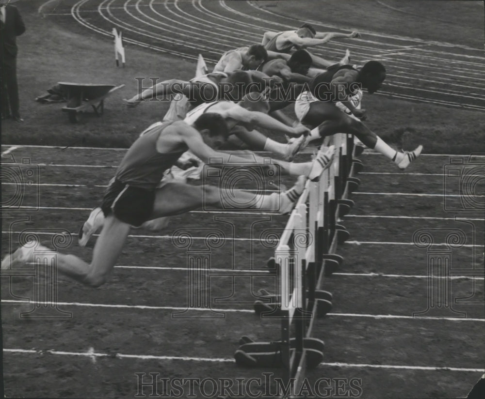 1965 Press Photo Western college track athletes leap over high hurdles at meet- Historic Images