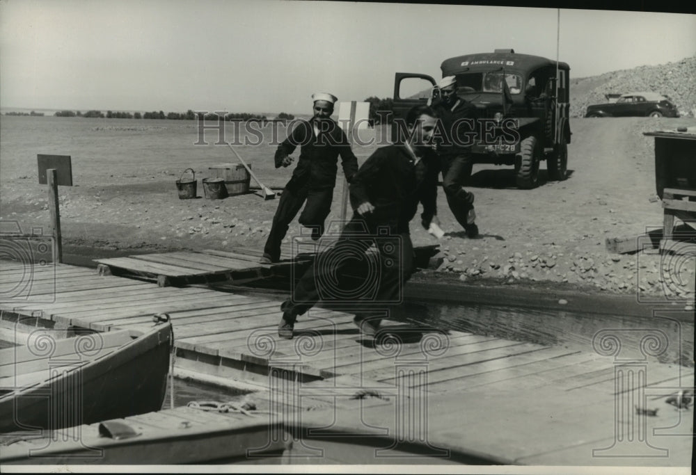 1944 Press Photo Three-man Boat Crew Dashing from Their Quarters to the Deck.- Historic Images