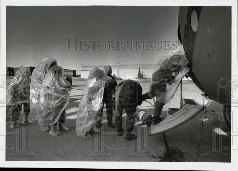 Load image into Gallery viewer, 1983 Press Photo Westover medical staff take off plastic before boarding a C-130
