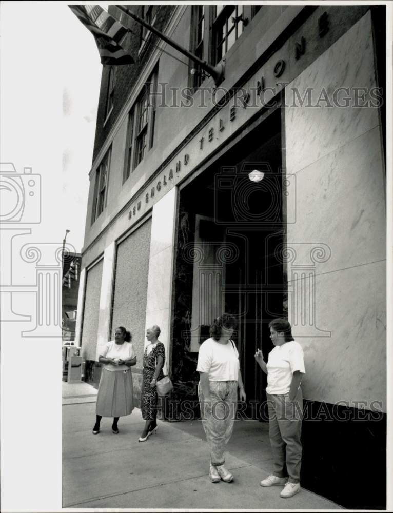 1990 Press Photo New England Telephone Co. workers on break outside building, MA- Historic Images